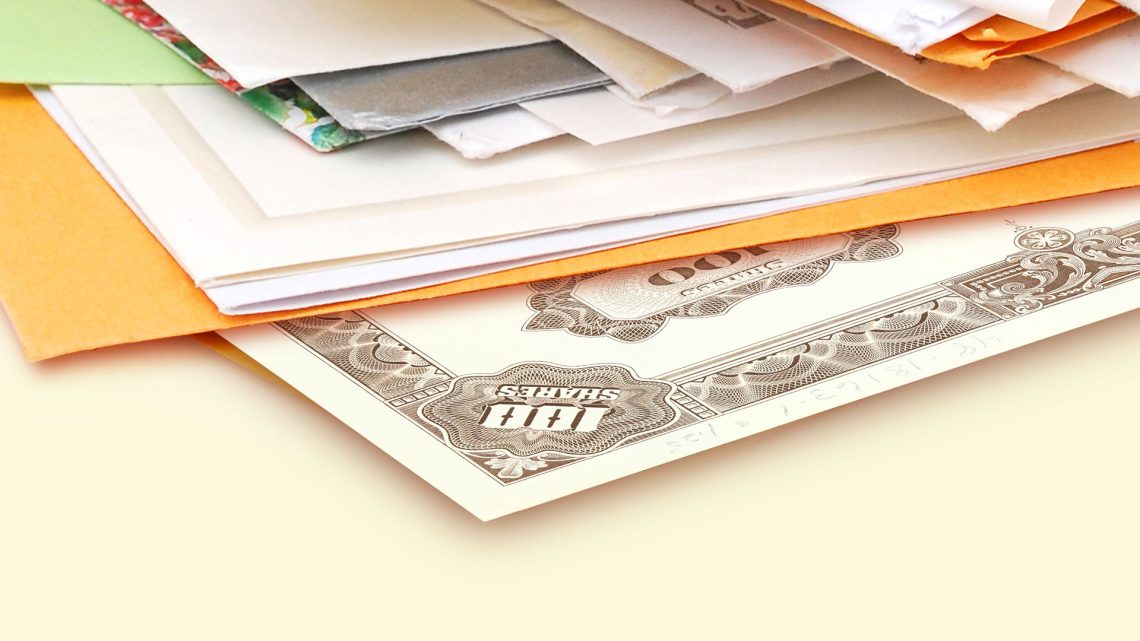 Stack of mail with stock certificate
