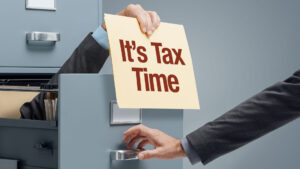 Sign saying "It's Tax Time" to promote being financially organized leading to easier tax preparation.