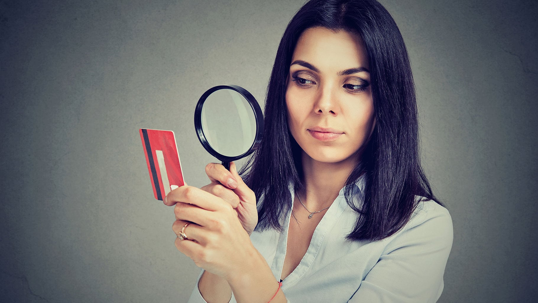 woman examining credit card because of rising interest rates